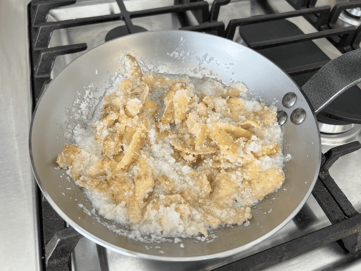 Pan with potatoes, oil, and salt in it